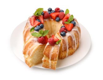 Photo of Delicious bundt cake with berries, glaze and mint isolated on white
