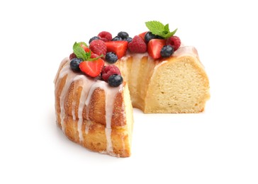 Photo of Piece of delicious bundt cake with berries, glaze and mint isolated on white