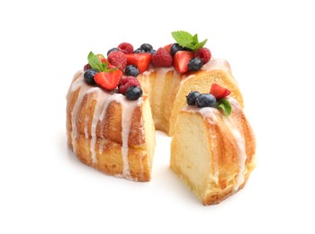 Photo of Pieces of delicious bundt cake with berries, glaze and mint isolated on white