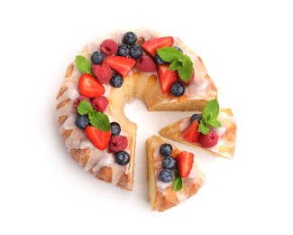 Photo of Pieces of delicious bundt cake with berries, glaze and mint isolated on white, top view