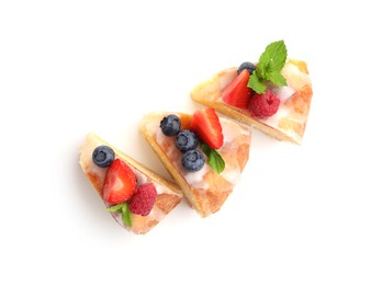 Photo of Pieces of delicious bundt cake with berries, glaze and mint isolated on white, top view