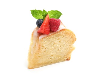 Photo of Piece of delicious bundt cake with berries, glaze and mint isolated on white