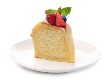 Photo of Piece of delicious bundt cake with berries, glaze and mint isolated on white