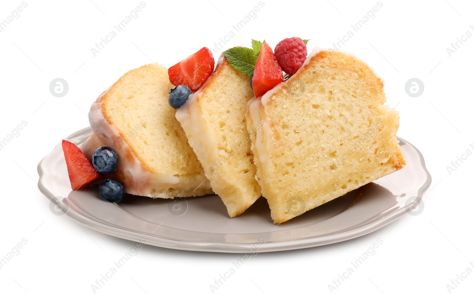 Pieces of delicious bundt cake with berries, glaze and mint isolated on white Photo of Pieces of delicious bundt cake with berries, glaze and mint isolated on white