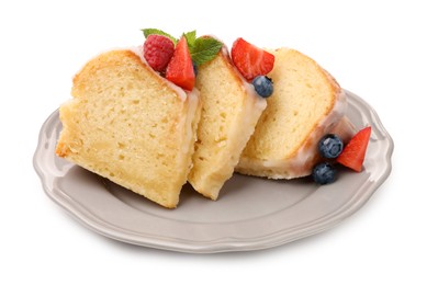 Photo of Pieces of delicious bundt cake with berries, glaze and mint isolated on white