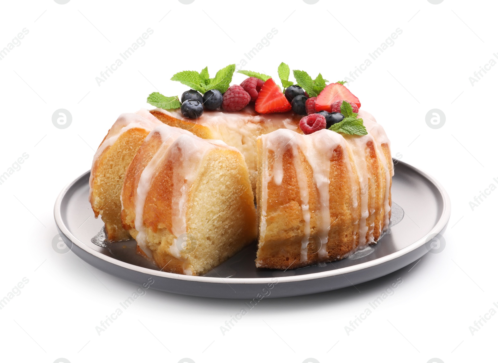 Photo of Pieces of delicious bundt cake with berries, glaze and mint isolated on white