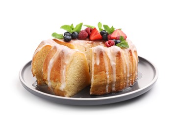 Photo of Pieces of delicious bundt cake with berries, glaze and mint isolated on white