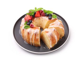 Photo of Pieces of delicious bundt cake with berries, glaze and mint isolated on white