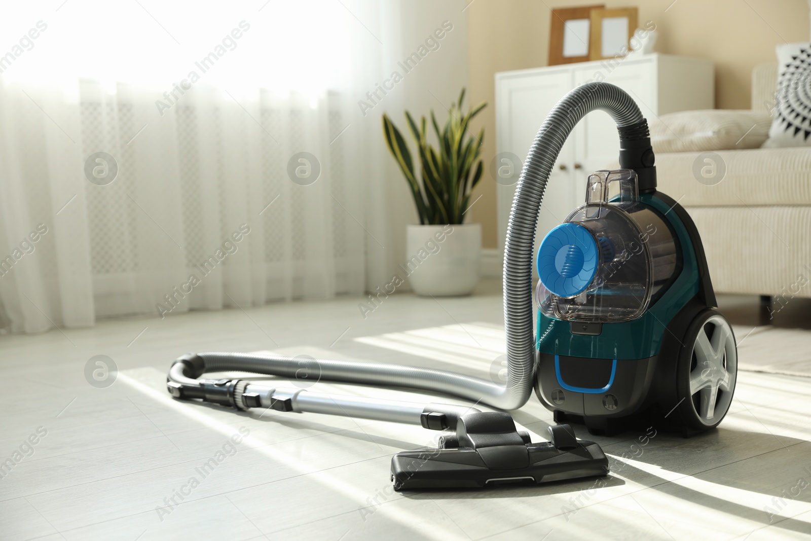 One vacuum cleaner on floor indoors. Household appliance Photo of One vacuum cleaner on floor indoors. Household appliance