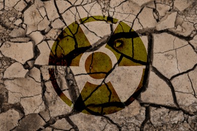 Image of Radioactive sign on cracked dry earth, top view. Radiological pollution