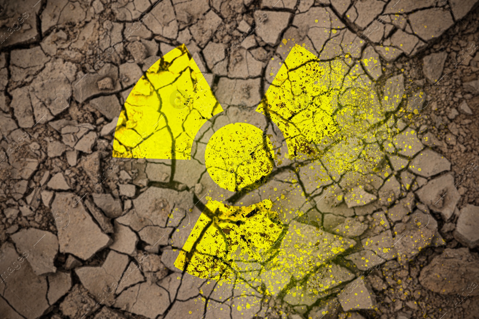 Image of Yellow radioactive sign on cracked dry earth, top view. Radiological pollution