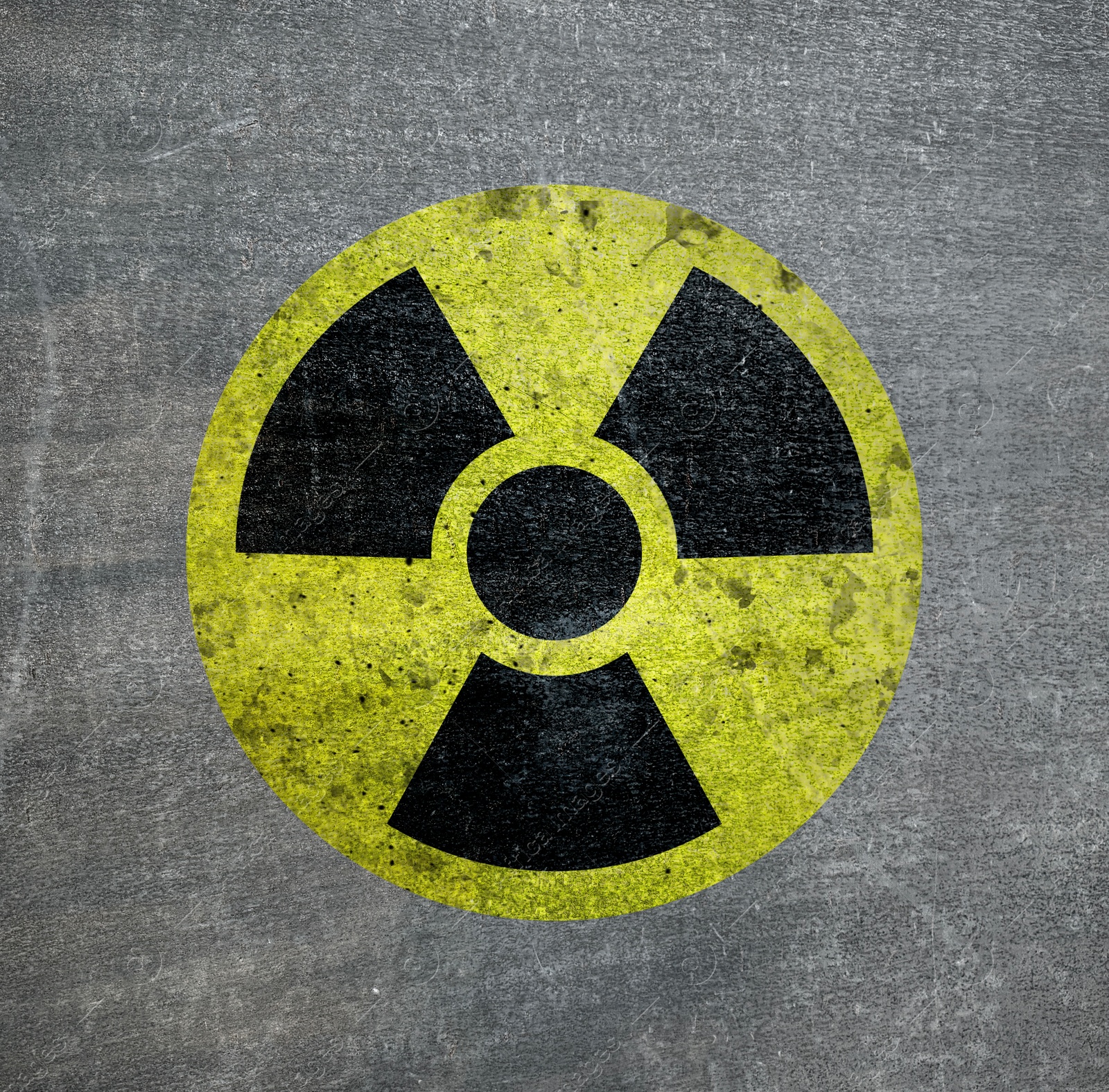 Image of Radioactive sign on grey textured surface. Radiological pollution