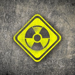 Image of Radioactive sign on grey textured surface. Radiological pollution