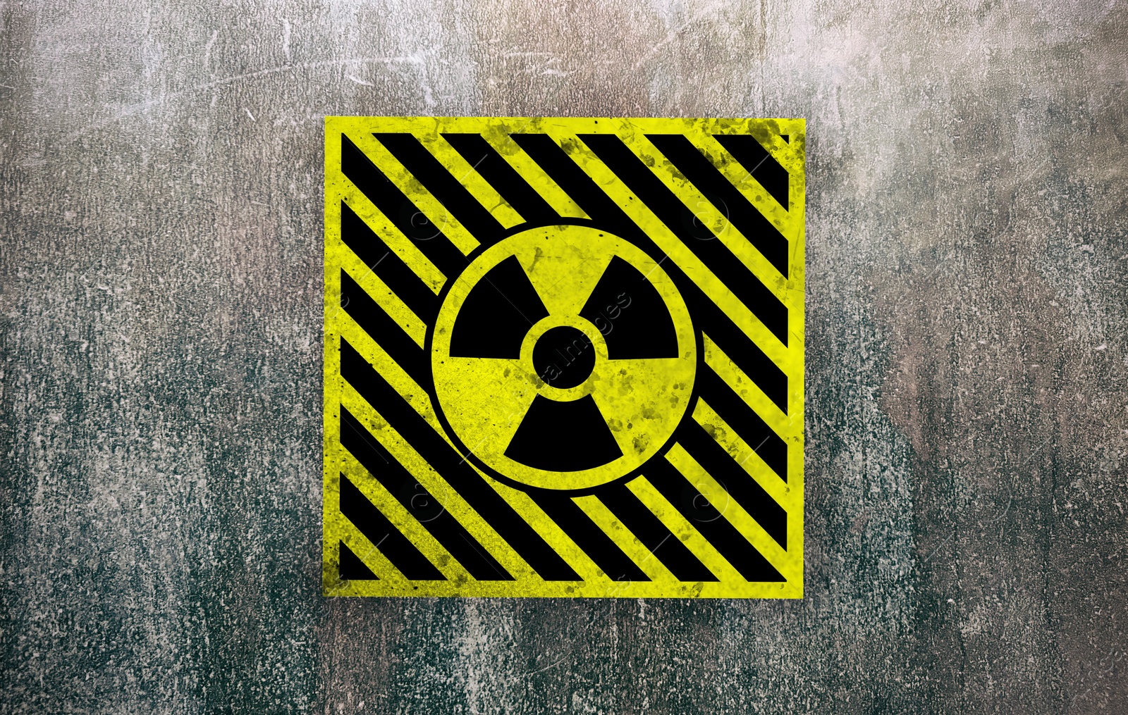 Image of Radioactive sign on grey textured surface. Radiological pollution