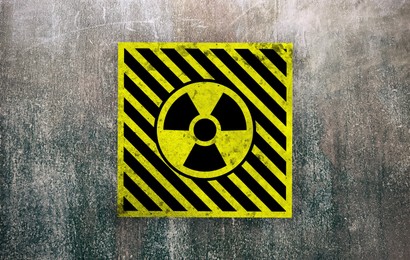 Image of Radioactive sign on grey textured surface. Radiological pollution