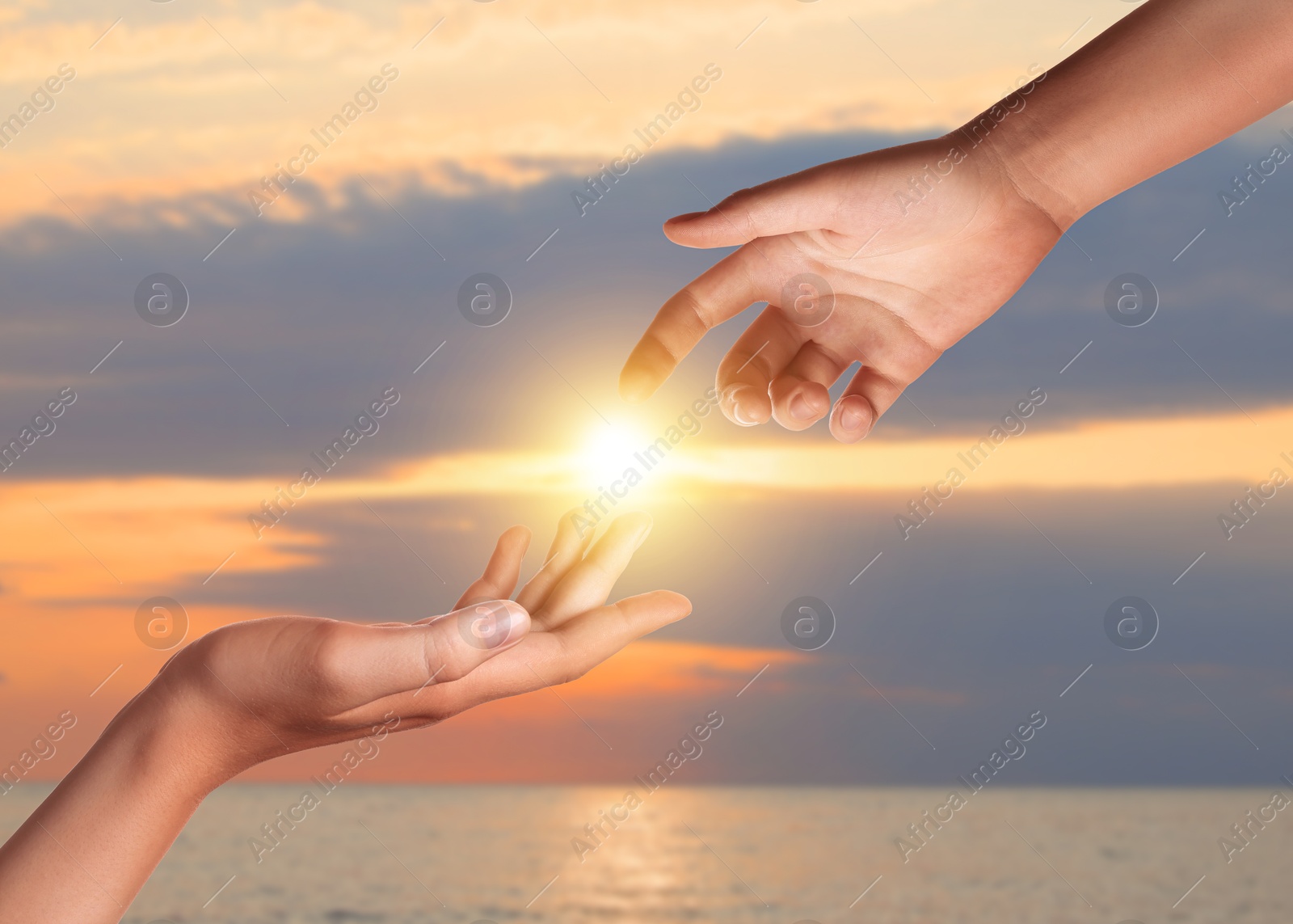 Hope. Women holding hands against sky with clouds and sun, closeup Image of Hope. Women holding hands against sky with clouds and sun, closeup