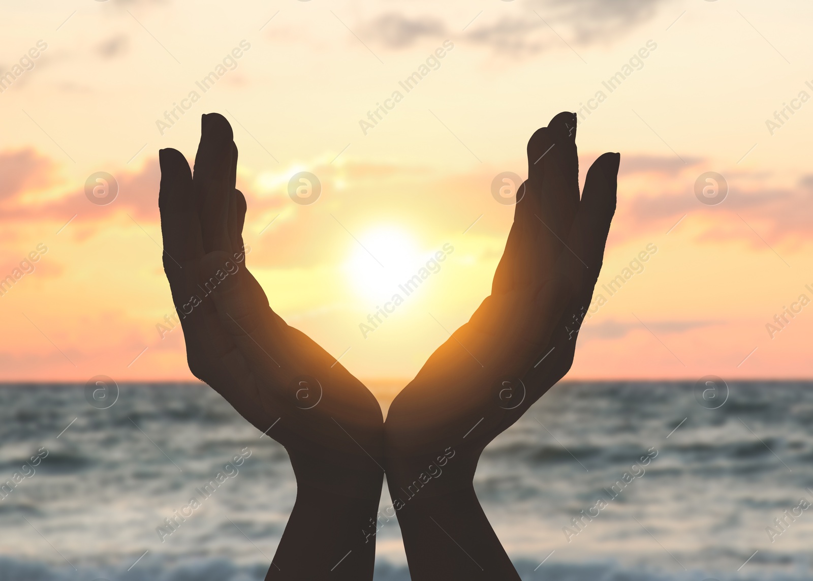 Hope. Woman holding hands against sky with clouds and sun, closeup Image of Hope. Woman holding hands against sky with clouds and sun, closeup