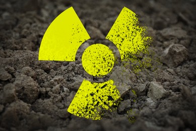 Image of Yellow radioactive sign on soil, closeup. Radiological pollution