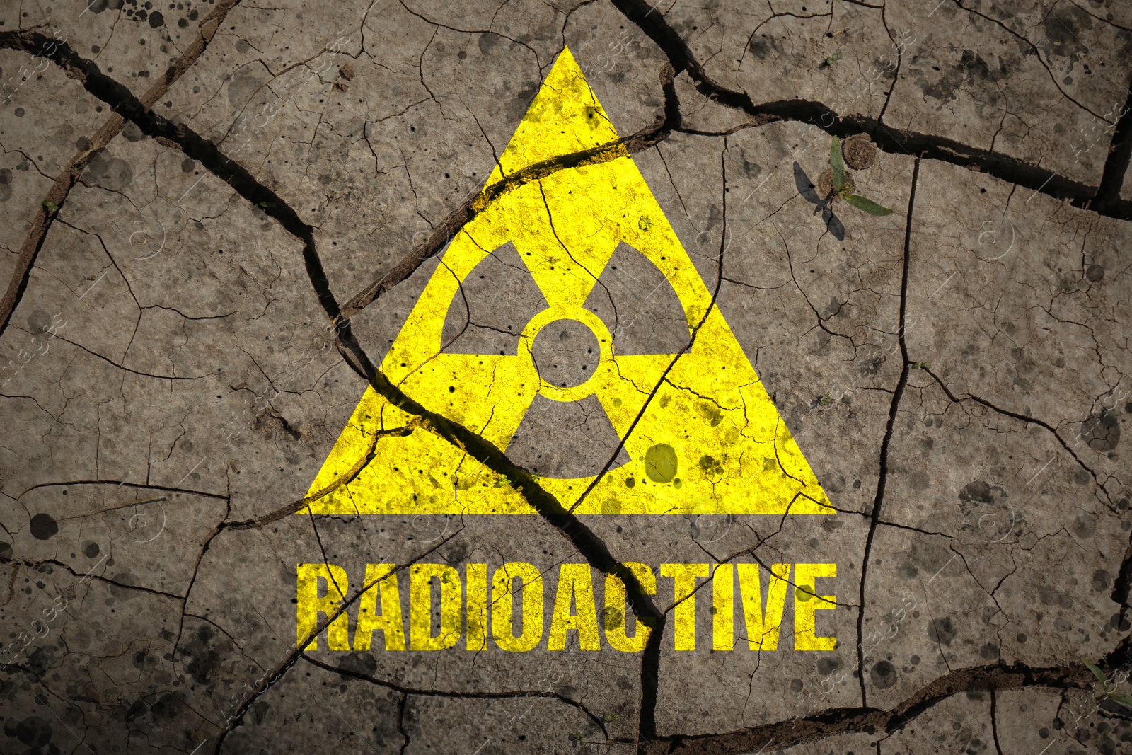 Yellow radioactive sign on cracked dry earth, top view. Radiological pollution Image of Yellow radioactive sign on cracked dry earth, top view. Radiological pollution