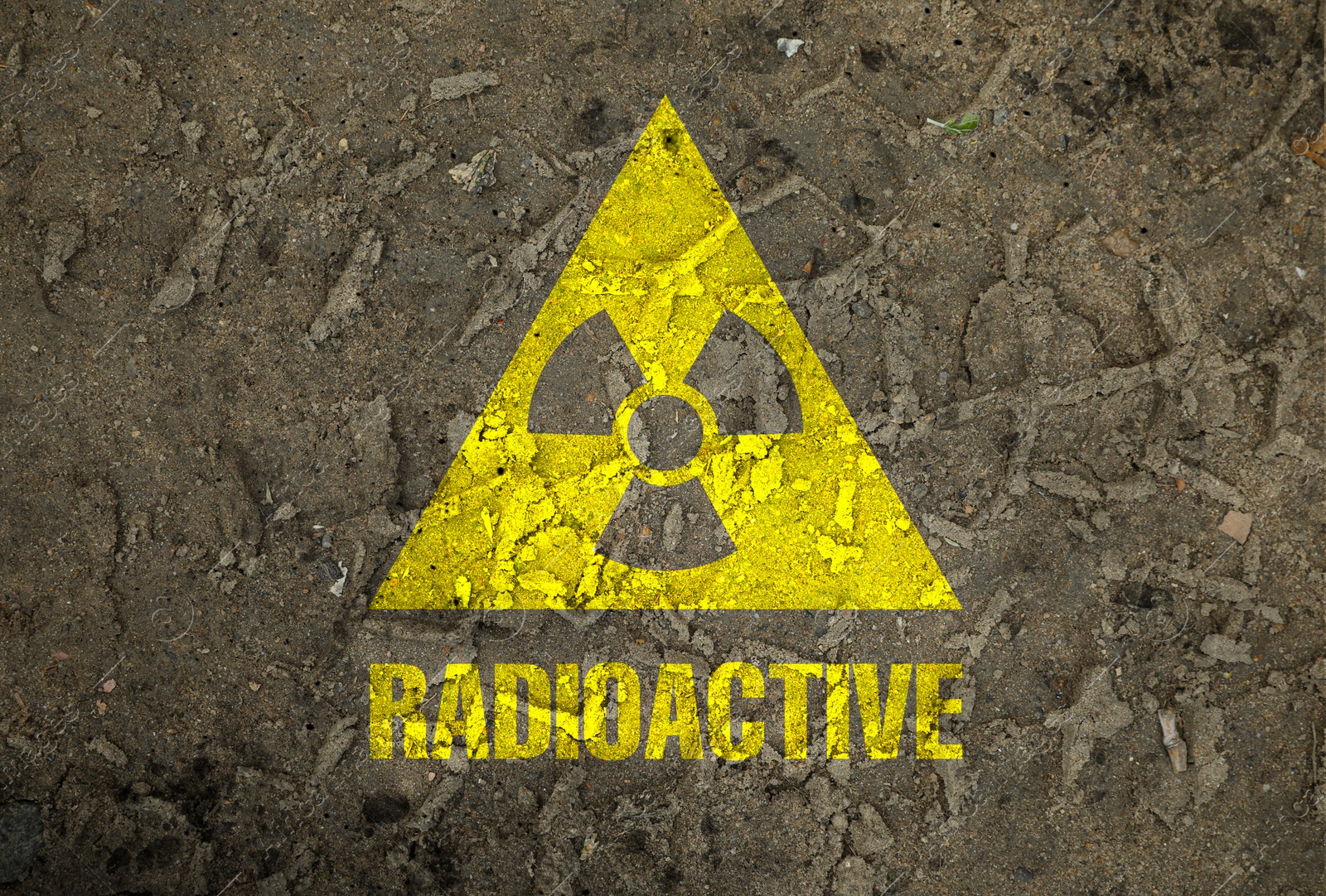 Yellow radioactive sign on ground with tire tracks, closeup. Radiological pollution Image of Yellow radioactive sign on ground with tire tracks, closeup. Radiological pollution