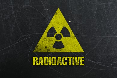 Image of Yellow radioactive sign on scratched black surface. Radiological pollution