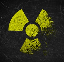 Image of Yellow radioactive sign on scratched black surface. Radiological pollution