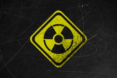 Image of Yellow radioactive sign on scratched black surface. Radiological pollution