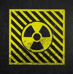 Image of Yellow radioactive sign on scratched black surface. Radiological pollution