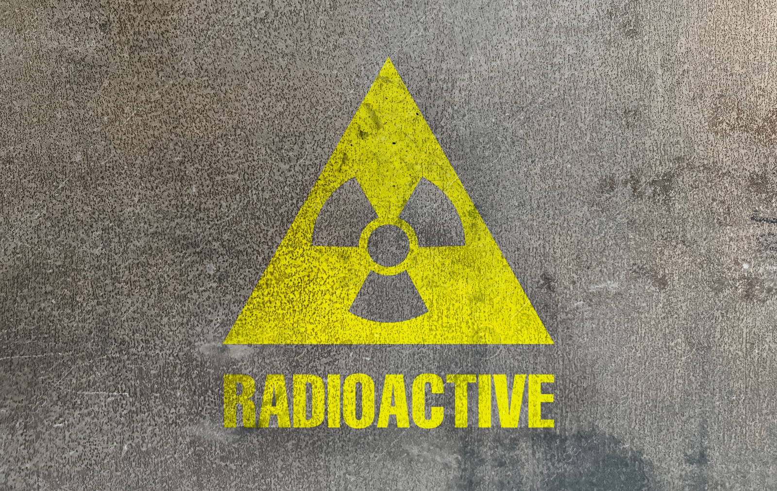 Image of Radioactive sign on grey textured surface. Radiological pollution