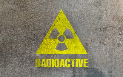 Image of Radioactive sign on grey textured surface. Radiological pollution