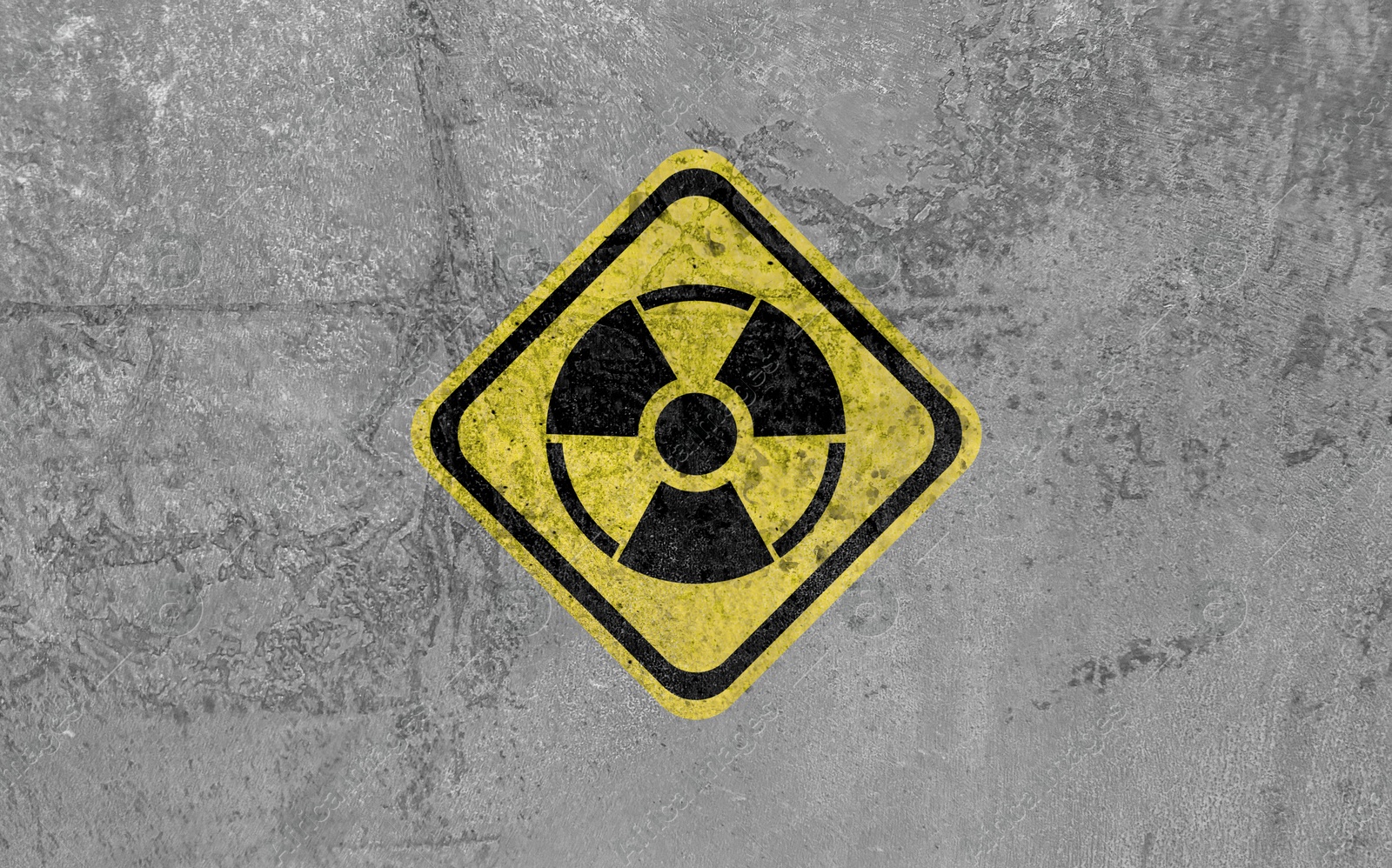 Image of Radioactive sign on grey textured surface. Radiological pollution