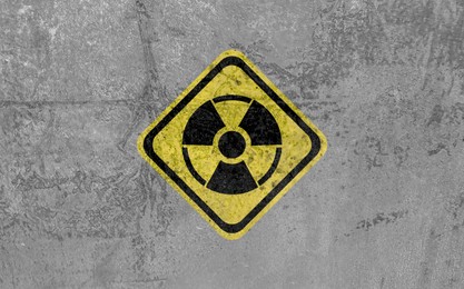 Image of Radioactive sign on grey textured surface. Radiological pollution