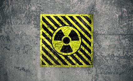 Image of Radioactive sign on grey textured surface. Radiological pollution
