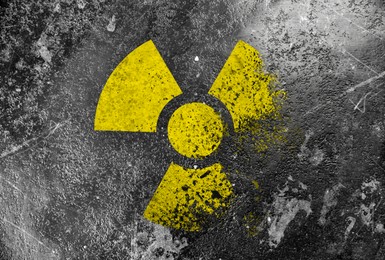 Image of Radioactive sign on grey textured surface. Radiological pollution