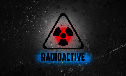 Image of Radioactive sign on black textured surface. Radiological pollution