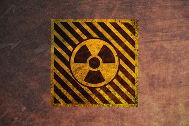 Image of Radioactive sign on brown textured background, banner design. Radiological pollution