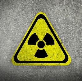 Image of Radioactive sign on grey textured surface. Radiological pollution