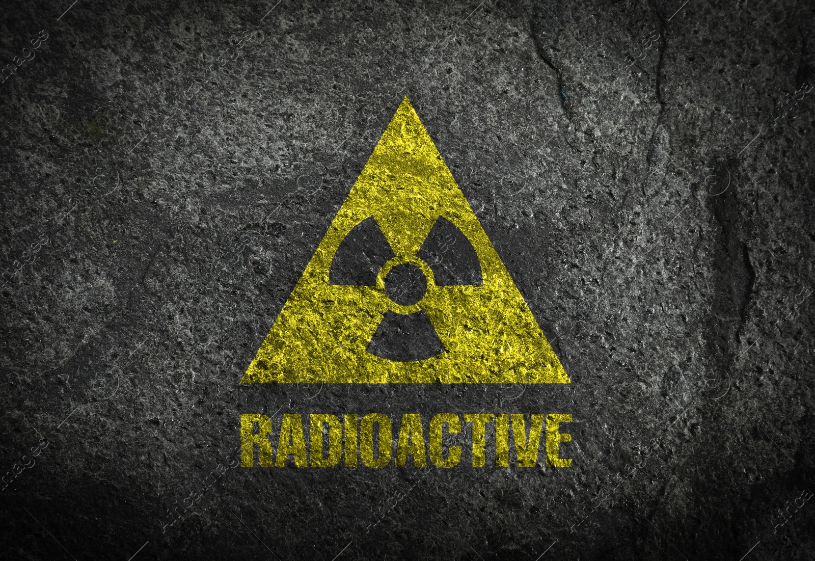 Image of Radioactive sign on dark grey textured surface. Radiological pollution