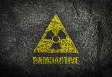 Image of Radioactive sign on dark grey textured surface. Radiological pollution