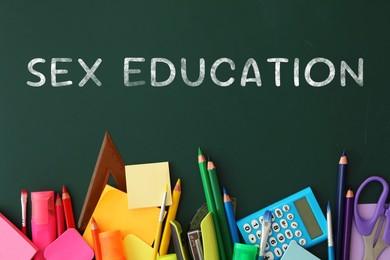 Image of Sex Education inscription and stationery on green chalkboard, top view