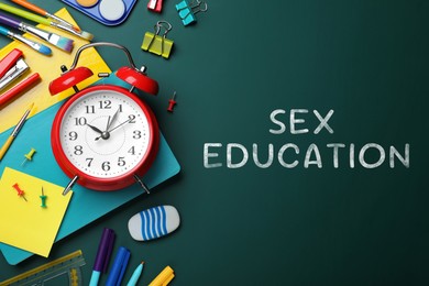 Image of Sex Education inscription and stationery on green chalkboard, top view