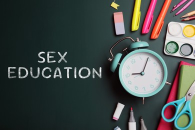 Image of Sex Education inscription and stationery on green chalkboard, top view