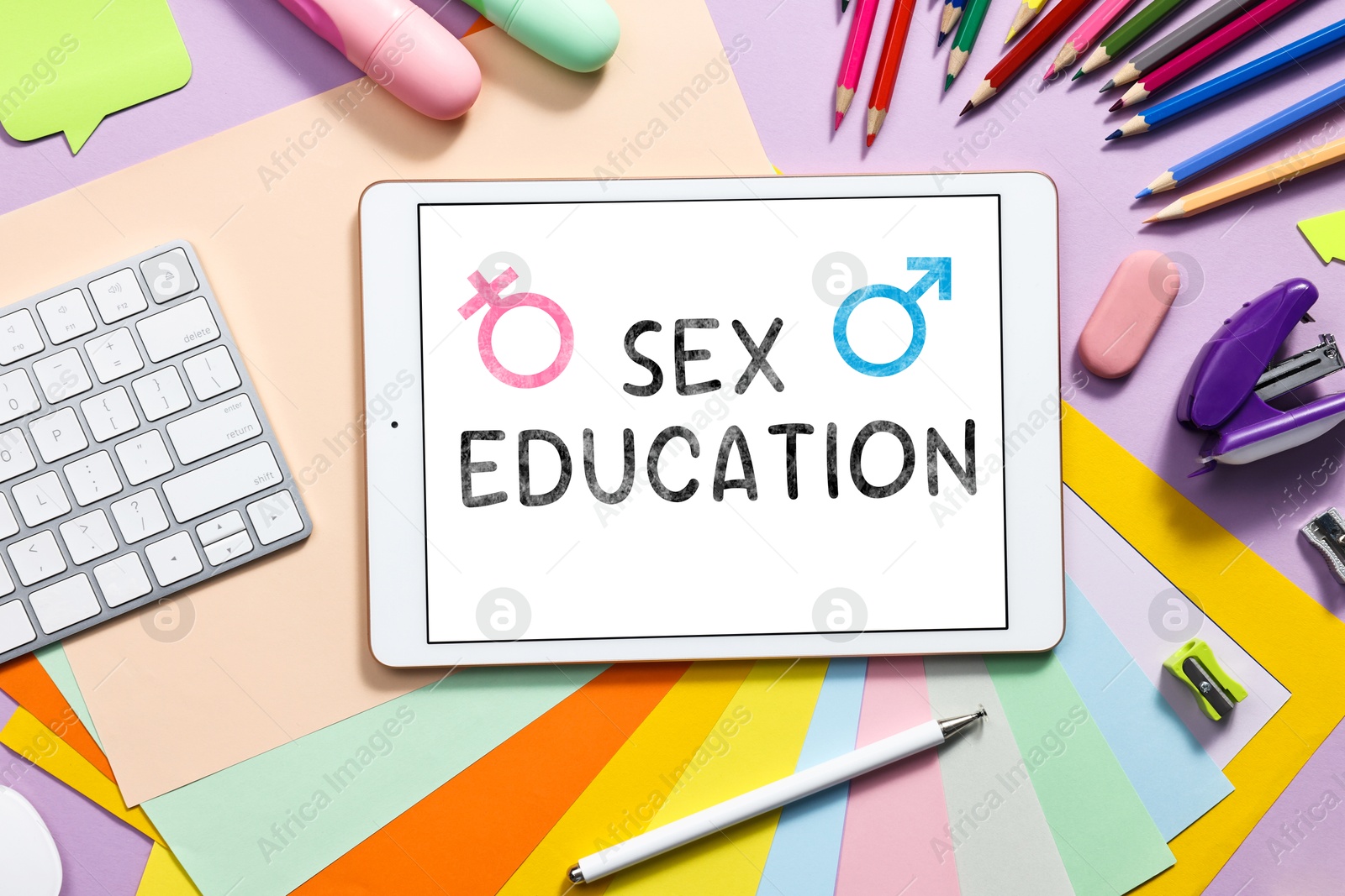 Image of Sex education. Tablet, computer keyboard and stationery on violet background, flat lay