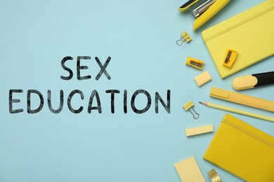 Image of Sex Education inscription and stationery on light blue background, top view