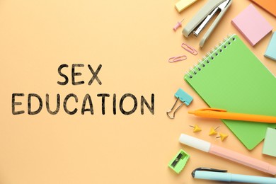 Image of Sex Education inscription and stationery on beige background, top view