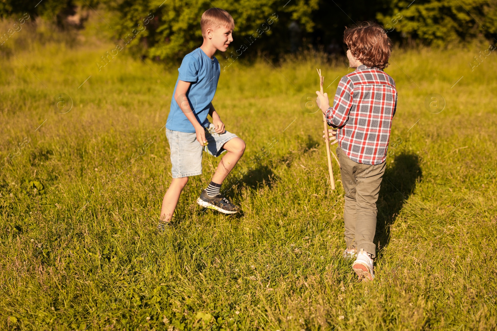 Cute little boys playing in nature on sunny day Photo of Cute little boys playing in nature on sunny day