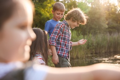 Photo of Children spending time in nature, selective focus