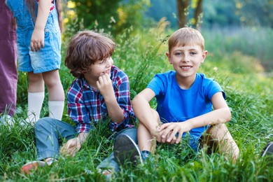 Photo of Children spending time in nature on summer day