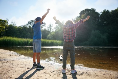Photo of Cute little boys spending time in nature on sunny day