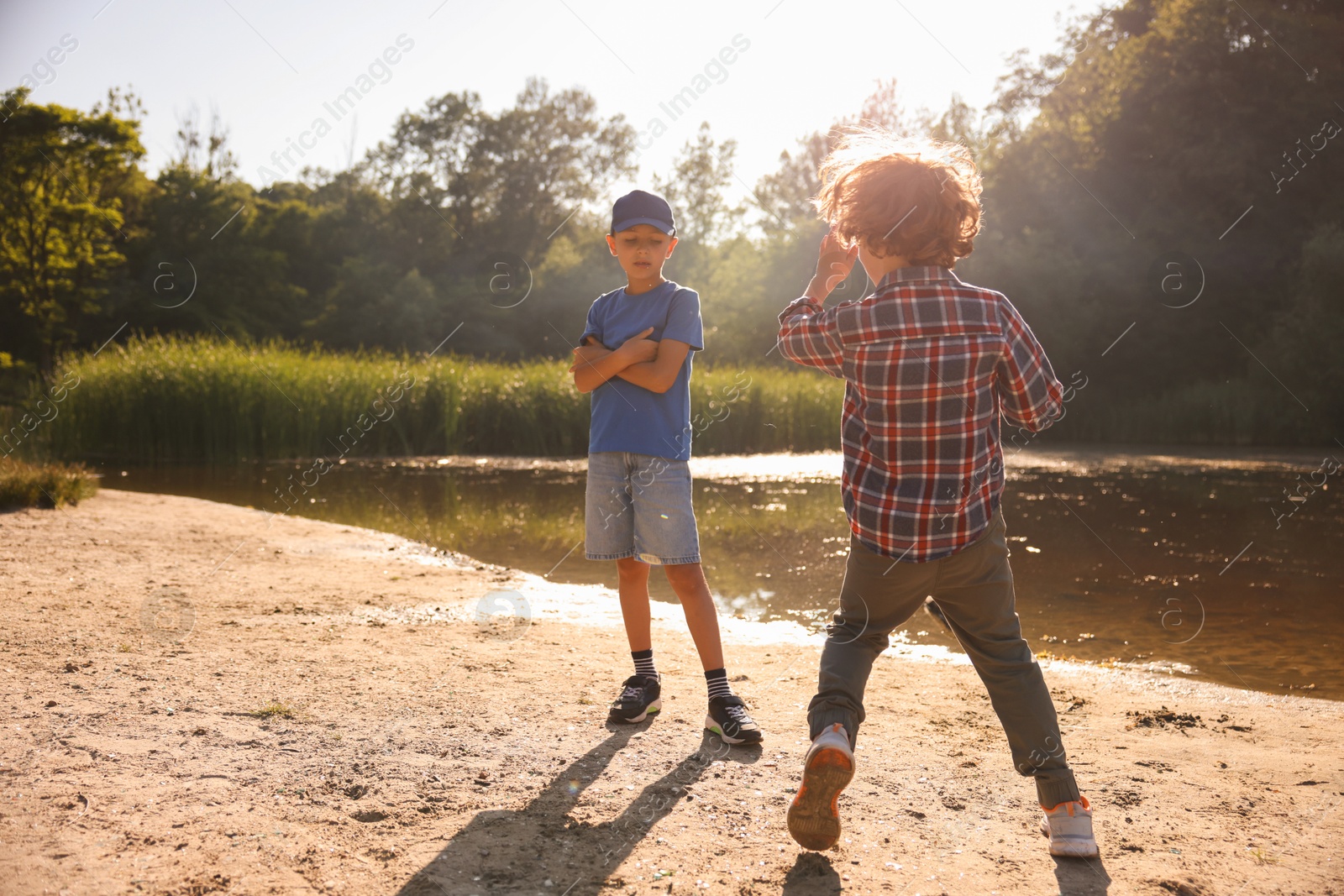 Cute little boys spending time in nature on sunny day Photo of Cute little boys spending time in nature on sunny day